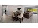 Open living room with dining area and patio access at 19891 Bridgetown Loop, Venice, FL 34293