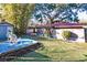 Charming backyard with a spacious lawn and a shed at 2005 E Crenshaw St, Tampa, FL 33610