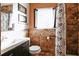 Clean bathroom with a shower/tub combo and brown tile at 2005 E Crenshaw St, Tampa, FL 33610
