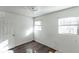 Simple bedroom with wood-look floors and two windows at 2005 E Crenshaw St, Tampa, FL 33610