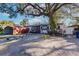 Home exterior showcasing landscaping and carport at 2005 E Crenshaw St, Tampa, FL 33610
