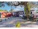 House exterior featuring walkway, landscaping, and large tree at 2005 E Crenshaw St, Tampa, FL 33610