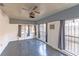 Living area with grey walls, tiled floors, and large windows at 2005 E Crenshaw St, Tampa, FL 33610