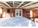 Enclosed porch with white wood floors and access to the backyard and pool at 2005 E Crenshaw St, Tampa, FL 33610