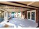 Spacious screened porch with white wood floors and a view of the backyard at 2005 E Crenshaw St, Tampa, FL 33610