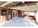 Covered porch with white wood floors and view of the backyard at 2005 E Crenshaw St, Tampa, FL 33610