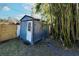 Metal storage shed with a wooden door at 2005 E Crenshaw St, Tampa, FL 33610