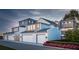 Rear view of three townhouses with attached garages and landscaping at 2550 1St N Ave, St Petersburg, FL 33713