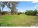 Expansive backyard with mature trees and open space at 3403 Overland Dr, Holiday, FL 34691