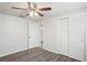 Bedroom with wood-look floors and white sliding doors at 3403 Overland Dr, Holiday, FL 34691
