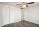 Bedroom with wood-look floors and sliding closet doors at 3403 Overland Dr, Holiday, FL 34691