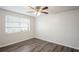 Well-lit bedroom with wood-look floors and a ceiling fan at 3403 Overland Dr, Holiday, FL 34691