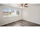 Bright bedroom with wood-look floors and a large window at 3403 Overland Dr, Holiday, FL 34691
