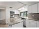 Modern kitchen with white cabinets, granite countertops, and island at 3403 Overland Dr, Holiday, FL 34691