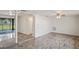 Spacious living room featuring tiled floors and access to the backyard at 3403 Overland Dr, Holiday, FL 34691