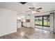 Open living room with kitchen views and sliding glass doors to the patio at 3403 Overland Dr, Holiday, FL 34691