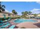 Relaxing kidney-shaped pool with lounge chairs and palm trees at 3875 Mariner Dr, St Petersburg, FL 33705