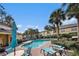 Inviting community pool with teal lounge chairs and umbrellas at 3875 Mariner Dr, St Petersburg, FL 33705