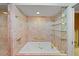 Renovated bathroom with a large bathtub and glass shelves at 3939 Venetian Way, Tampa, FL 33634