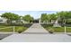 White dock leading to home with pool and lush landscaping at 3939 Venetian Way, Tampa, FL 33634