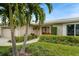Home's entrance with lush landscaping at 3939 Venetian Way, Tampa, FL 33634