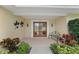 Inviting front entry with double doors, a tiled floor, and landscaping at 3939 Venetian Way, Tampa, FL 33634