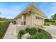 Tan colored garage with a neatly landscaped yard at 3939 Venetian Way, Tampa, FL 33634