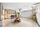 Unfinished garage with overhead storage and door to house at 3939 Venetian Way, Tampa, FL 33634