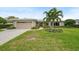 Single-story home with attached garage and attractive landscaping at 3939 Venetian Way, Tampa, FL 33634