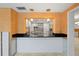 Kitchen with breakfast bar and orange accent wall at 3939 Venetian Way, Tampa, FL 33634