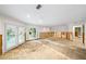 Large living room with pool view, currently undergoing renovation with exposed walls and flooring at 3939 Venetian Way, Tampa, FL 33634