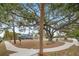 Curved pathway winds through a park with playground and large tree at 3939 Venetian Way, Tampa, FL 33634