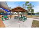 Wooden park pavilion with picnic tables at 3939 Venetian Way, Tampa, FL 33634