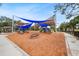 Modern playground with blue shade sails and wood-chip surface at 3939 Venetian Way, Tampa, FL 33634