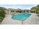 Large kidney-shaped pool with patio and canal view at 3939 Venetian Way, Tampa, FL 33634