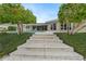 Stone steps leading to a beautiful home with a pool and lush landscaping at 3939 Venetian Way, Tampa, FL 33634