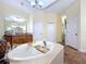 Large bathroom with garden tub, double vanities, and separate shower at 4178 Des Prez Ct, Hernando Beach, FL 34607