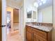 Bathroom with granite countertop and wood cabinets at 4178 Des Prez Ct, Hernando Beach, FL 34607