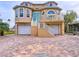 Tan two-story house with white trim, two-car garage, and a brick driveway at 4178 Des Prez Ct, Hernando Beach, FL 34607