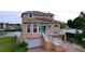 Tan two-story house with white trim, two-car garage, and a brick driveway at 4178 Des Prez Ct, Hernando Beach, FL 34607