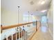Upstairs hallway with light colored walls and wood railing at 4178 Des Prez Ct, Hernando Beach, FL 34607