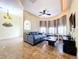 Living room with bay window, gray sectional sofa, and tile floors at 4178 Des Prez Ct, Hernando Beach, FL 34607