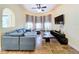Bright living room featuring a sectional sofa, large TV, and ample natural light at 4178 Des Prez Ct, Hernando Beach, FL 34607