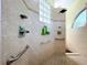 Walk-in shower with glass block window and dual shower heads at 4178 Des Prez Ct, Hernando Beach, FL 34607