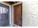 Condo building entrance with brown door and screen door at 4215 E Bay Dr # 1702A, Clearwater, FL 33764