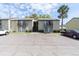 Condo building exterior with parking and palm trees at 4215 E Bay Dr # 1702A, Clearwater, FL 33764