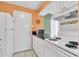 White kitchen features granite countertops and a microwave at 4215 E Bay Dr # 1702A, Clearwater, FL 33764