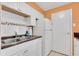 Bright kitchen with white cabinets, granite countertops, and modern appliances at 4215 E Bay Dr # 1702A, Clearwater, FL 33764