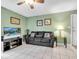 Living room with black leather couch and TV at 4215 E Bay Dr # 1702A, Clearwater, FL 33764