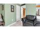 Living room with black leather chair and view of bathroom at 4215 E Bay Dr # 1702A, Clearwater, FL 33764